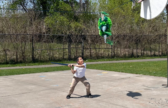  boy hitting a pinata with a bat